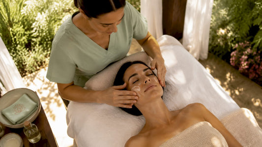 Esthetician applying post-facial serum in spa room